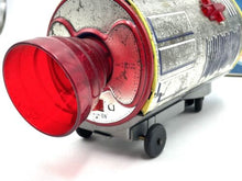Load image into Gallery viewer, Detailed view of the red metallic lens on the vintage battery-operated space capsule toy.