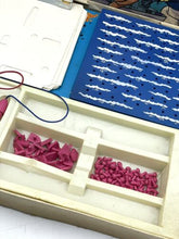 Load image into Gallery viewer, Detail close-up of organized game pieces in a tray with blue and red colors.