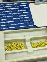 Load image into Gallery viewer, Detail close-up of organized game pieces in a tray with blue and yellow colors.