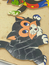 Load image into Gallery viewer, Detail of a black cat puzzle piece with large eyes and cartoon style.