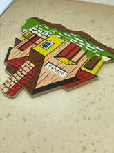 Load image into Gallery viewer, Detail of a colorful house-shaped puzzle piece with bright colors.