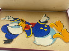 Load image into Gallery viewer, Detail of a blue, red, and yellow Donald Duck puzzle piece.