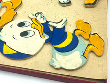 Load image into Gallery viewer, Detail of a blue and yellow Donald Duck puzzle piece.