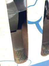 Load image into Gallery viewer, Close-up of a shiny silver and black metal object with curved edges.
