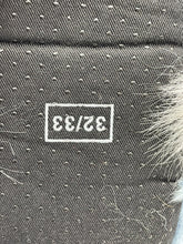 Load image into Gallery viewer, Close-up of the tag on a blue Vintage Furby Slipper displaying the brand logo.