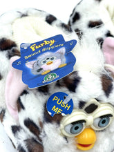 Load image into Gallery viewer, Close-up of a white and brown plush toy with a tag and big eyes.