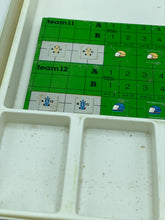 Load image into Gallery viewer, Another close-up of the green game board from GRAND PRIX highlighting its grid pattern and small icons.