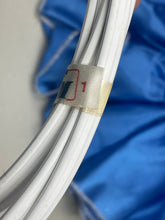 Load image into Gallery viewer, Detail shot of gray fabric featuring decorative elements on a solid background