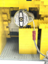 Carica l'immagine nel visualizzatore di Gallery, LEGO mechanism close-up displaying a circular part and wires.