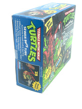 Load image into Gallery viewer, BANDAI Playmates TMNT Sewer Party Tube side view showcasing colorful packaging.