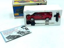 Load image into Gallery viewer, Takara Transformers G1 Sideswipe lifestyle view of toy car in box with accessories.