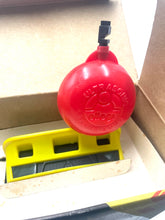 Load image into Gallery viewer, Close-up detail of a red float and yellow level tool.