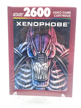 Load image into Gallery viewer, Atari 2600 Xenophobe game box front view with purple, blue, and red colors.