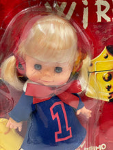 Carica l'immagine nel visualizzatore di Gallery, Front view of the doll's face featuring blue eyes and blonde hair with a red scarf.