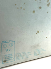 Carica l'immagine nel visualizzatore di Gallery, Detail of metal surface with stains and text markings.