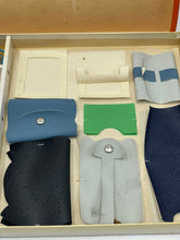 Load image into Gallery viewer, Spear's Game detail of folded items and box compartment.