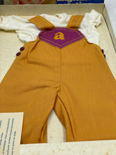 Load image into Gallery viewer, Close-up detail of Sebino doll dress showing overalls design and soft fabric.