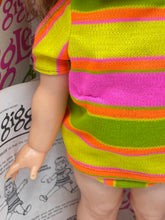 Load image into Gallery viewer, Detail of Ideal Toy Giggles doll's striped outfit in pink, green, and yellow.