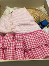 Load image into Gallery viewer, Detail view of clothing items featuring a ruffled skirt and button details.