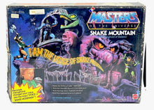 Load image into Gallery viewer, Mattel Masters of the Universe Snake Mountain packaging front view with character illustrations.