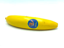Load image into Gallery viewer, Furga mini Banana Doll side view with yellow banana and sticker label.