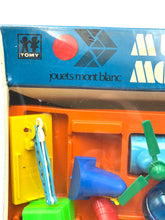 Load image into Gallery viewer, Detail view of Tomy Jouets Mont Blanc Multi mobile with colorful pieces and small accessories.