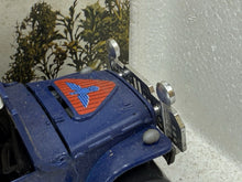 Load image into Gallery viewer, Detail close-up of the blue toy truck hood with triangular emblem and chrome details.