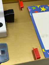 Load image into Gallery viewer, Detail close-up of toy parts showcasing small red pieces with Mickey Mouse graphic.