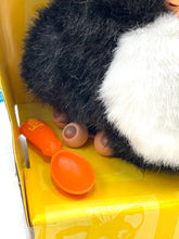 Carica l'immagine nel visualizzatore di Gallery, Detail shot of black and white plush Furby showing paw and orange spoon.