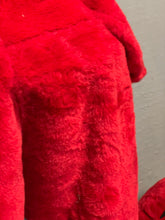 Load image into Gallery viewer, Detail view of red plush fabric with a rounded edge.