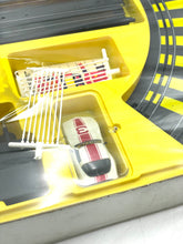 Load image into Gallery viewer, Detail view of Tyco slot car components including wires and track pieces.