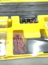 Load image into Gallery viewer, Detail view of Tyco slot car components featuring car model and track pieces.