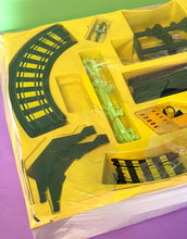 Load image into Gallery viewer, Detail close-up of Tyco track pieces in various shapes with colorful designs.