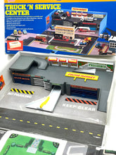 Load image into Gallery viewer, Galoob Micro Machines Truck 'N Service Centre packaging featuring a detailed city layout and multiple buildings.