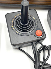 Load image into Gallery viewer, Close-up detail of Atari VCS 2600 game controller with circular button.
