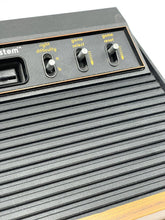 Load image into Gallery viewer, Atari VCS 2600 Woody console close-up of input ports and branding.
