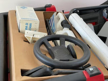 Load image into Gallery viewer, Close-up of authentic Peg Perego logos and decals on the vehicle.

