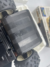 Load image into Gallery viewer, Detail of the Nikko Black Cat Laser 4WD brand logo on a black surface.

