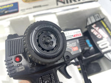 Load image into Gallery viewer, Close-up detail of the Nikko Black Cat Laser 4WD wheels and control buttons.
