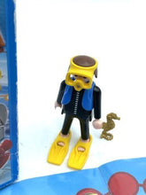 Load image into Gallery viewer, Detail close-up of the diver figure with diving gear and a small animal.
