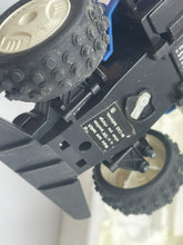 Load image into Gallery viewer, Close-up of car undercarriage highlighting suspension system and wheel details.
