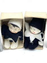 Load image into Gallery viewer, Front view of two boxed dolls with distinct outfits in black and white.
