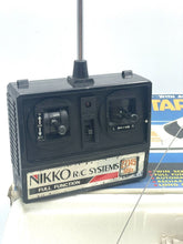 Load image into Gallery viewer, Close-up of the remote control for Vintage Nikko Caribic Star Speed Cruiser showing buttons and antenna.
