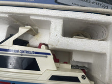 Load image into Gallery viewer, Detail of the toy boat model showing styrofoam packaging and colors of white, blue, and red.
