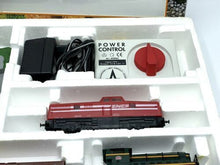 Load image into Gallery viewer, Detail view of Lima train set contents showcasing various train models and instruction manual.
