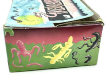 Load image into Gallery viewer, Detail shot of the edge of the lottery ticket box showing slight wear.

