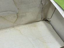 Load image into Gallery viewer, Detail shot of the inside corner of the lottery ticket box showing visible stains.
