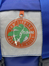 Load image into Gallery viewer, Close-up of the logo patch featuring a circular design and leaf graphic.
