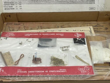 Load image into Gallery viewer, Carta Augusto model ship kit components including various tools and an instruction sheet.

