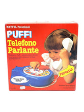 Load image into Gallery viewer, THE SMURFS I PUFFI IL TELEFONO PARLANTE MATTEL packaging view with colorful design and child holding phone.
